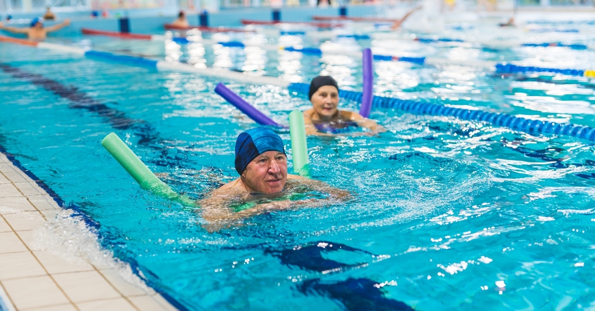 senior adult couple swimming in a sport pool