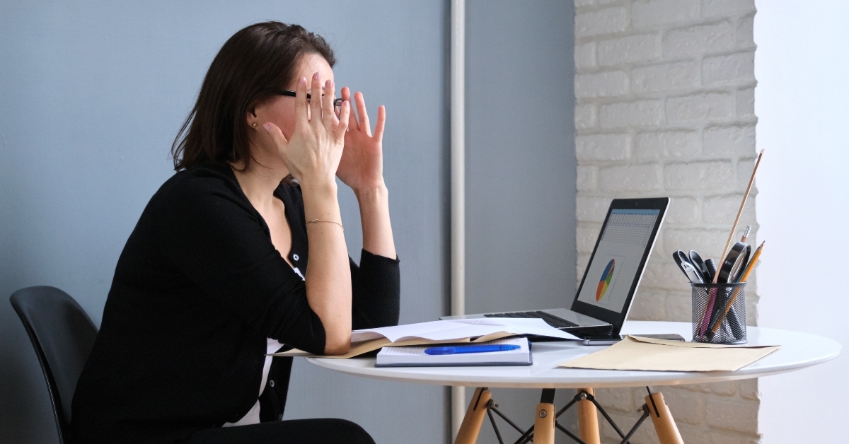 middle-aged woman with papers and laptop