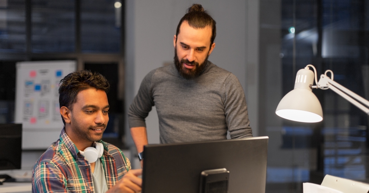 creative team with computers working together late at night office