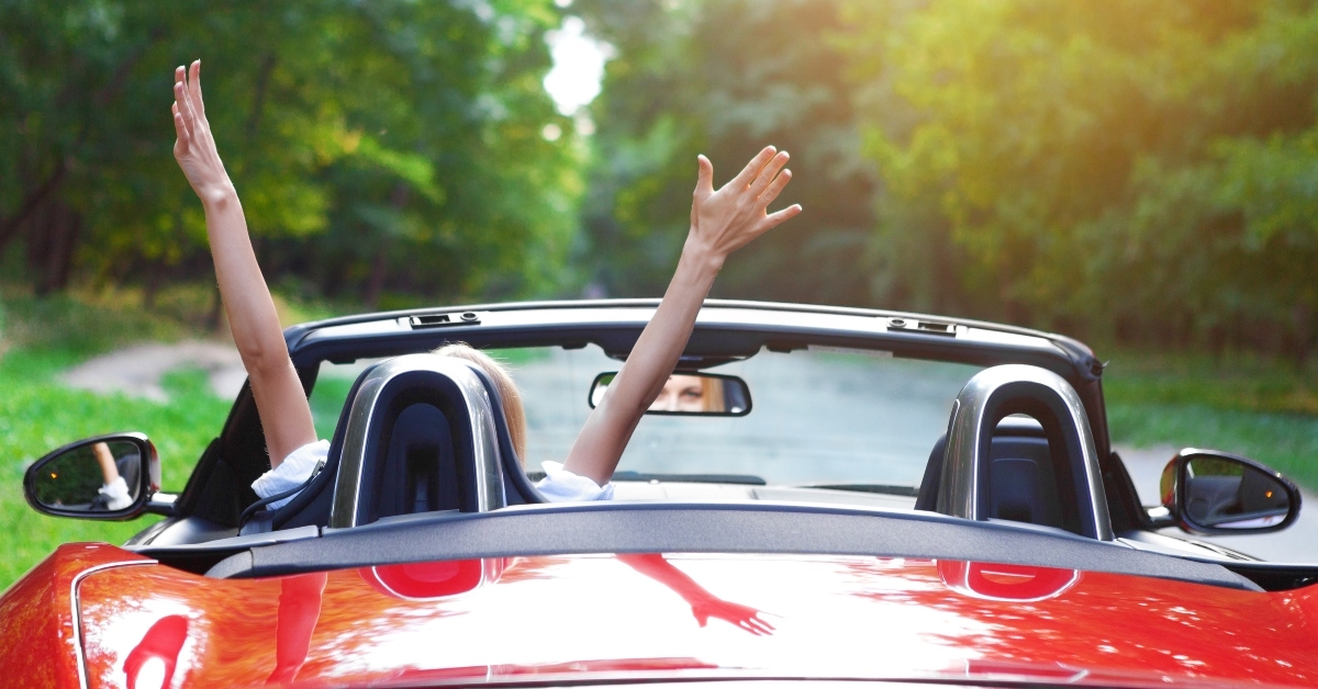 young woman driving a sports car