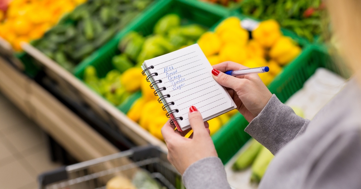 woman with notebook in grocery store