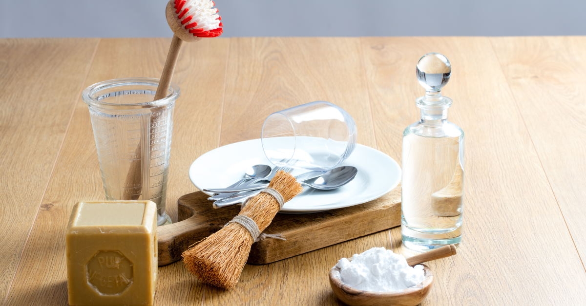 dishes placed with home made detergents in glass jar and pestle with soap bar