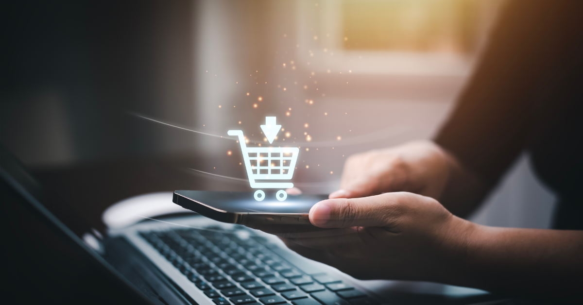 man using smartphone and laptop at home for online shopping with 3d cart online shopping concept