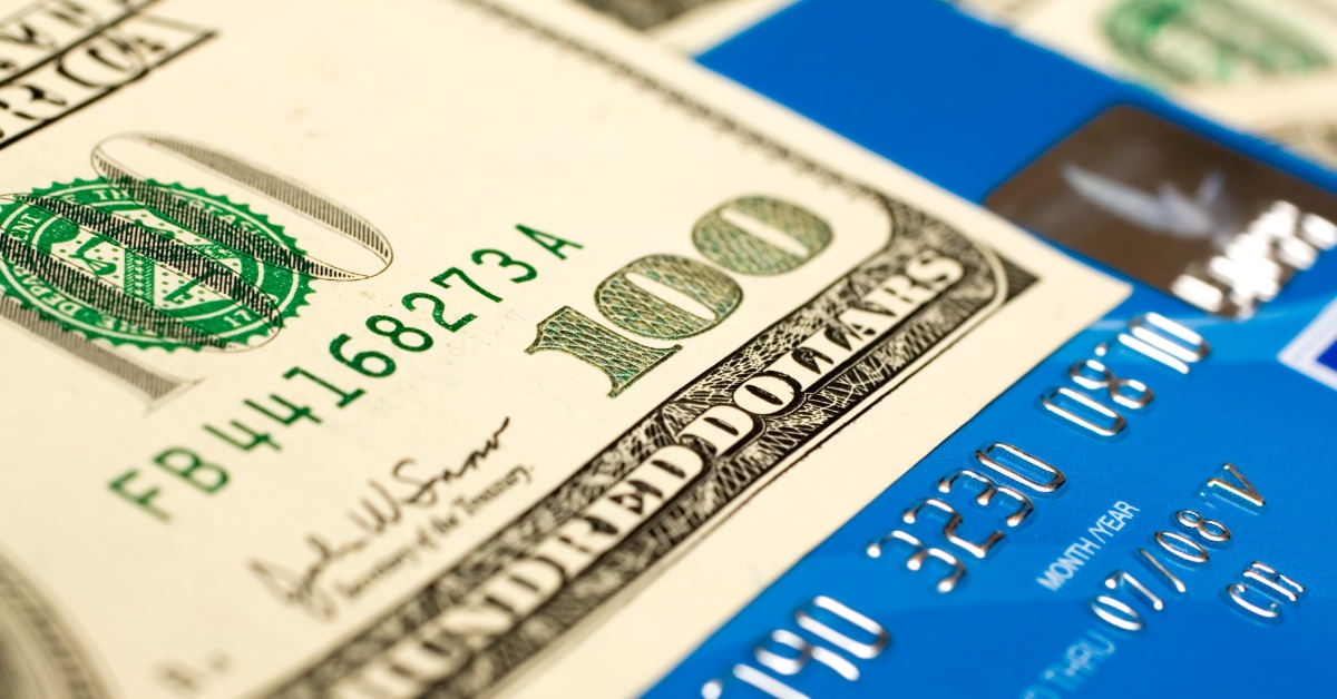 close up of one hundred dollar note on top of card