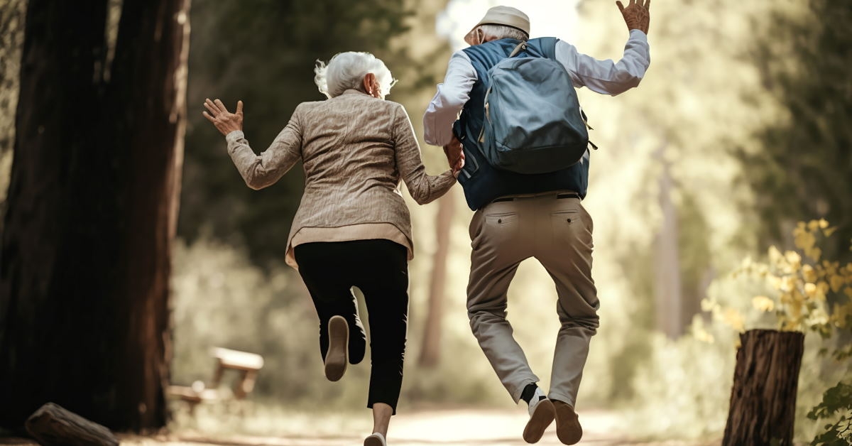 happy senior couple doing sprints in forest 
