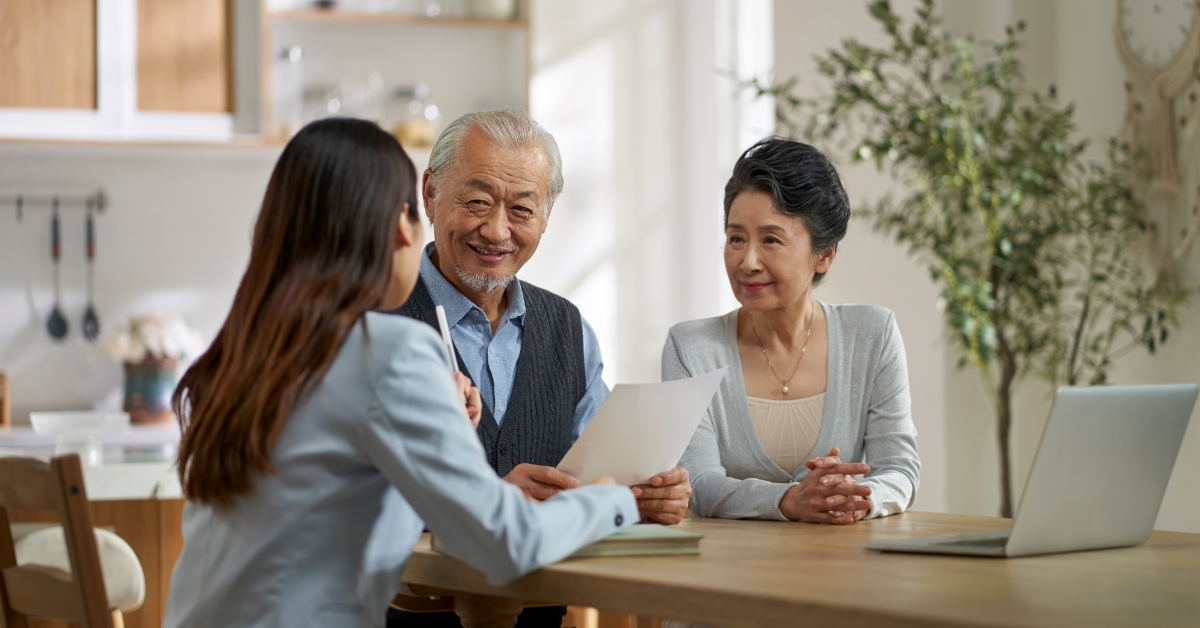 senior asian couple sitting at table discussing finance