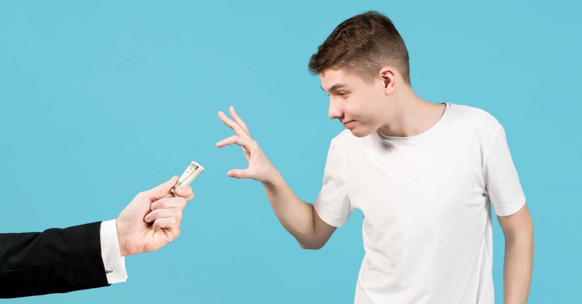 teenage boy taking money from a man in suit