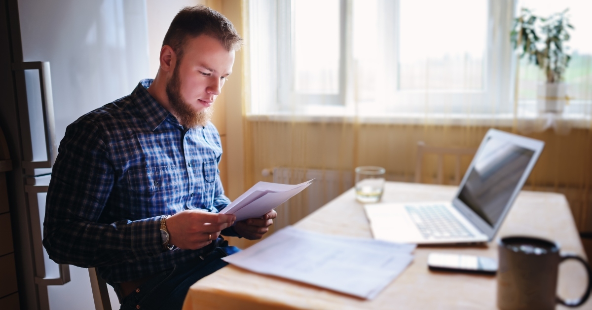 man doing some paperwork at home