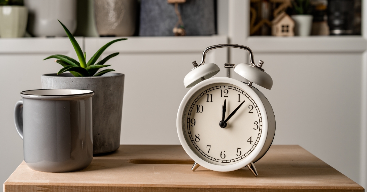 alarm clock stands on a wooden table