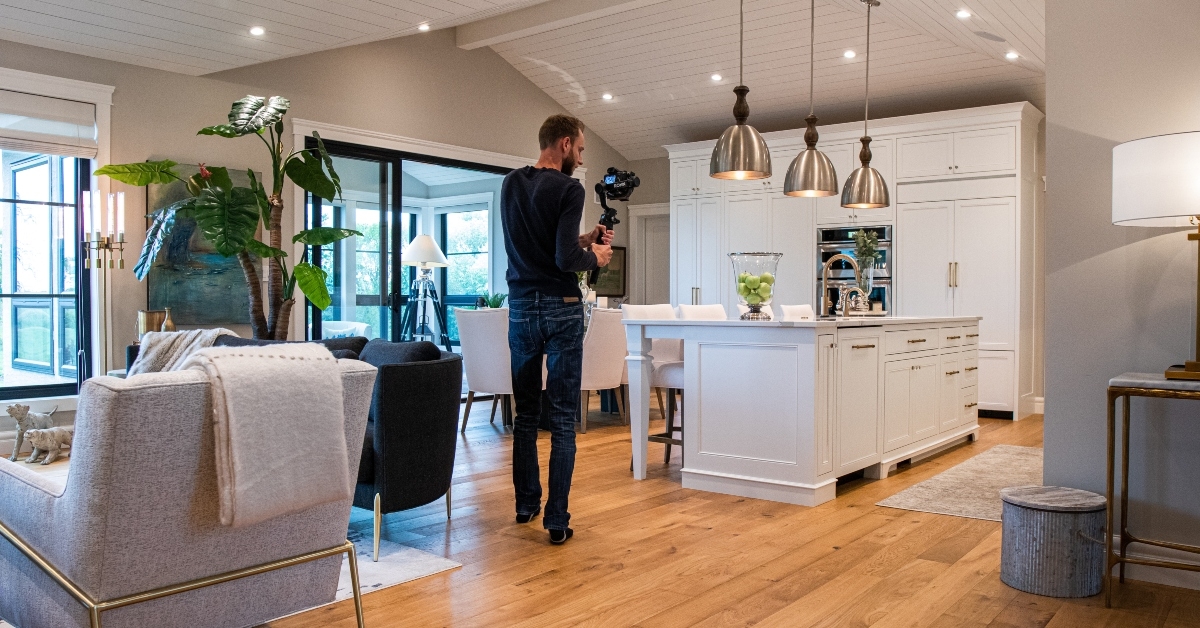 A cameraman walking through house