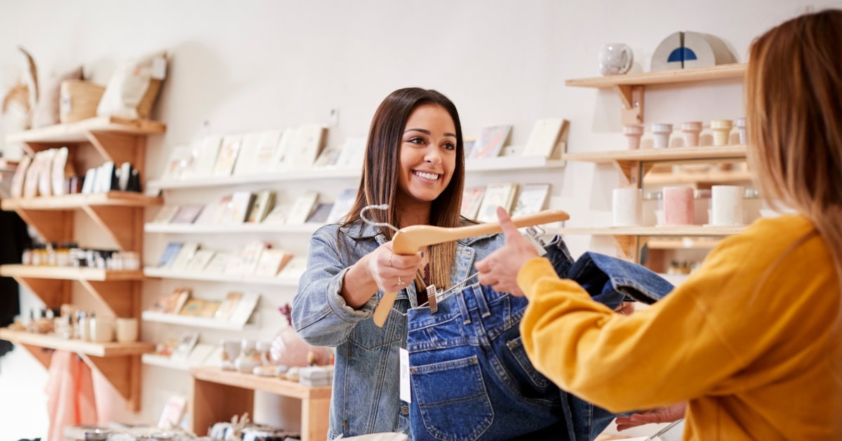 female sales assistant holding denim