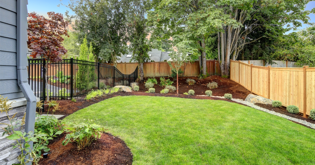 nice fenced backyard with new planting beds