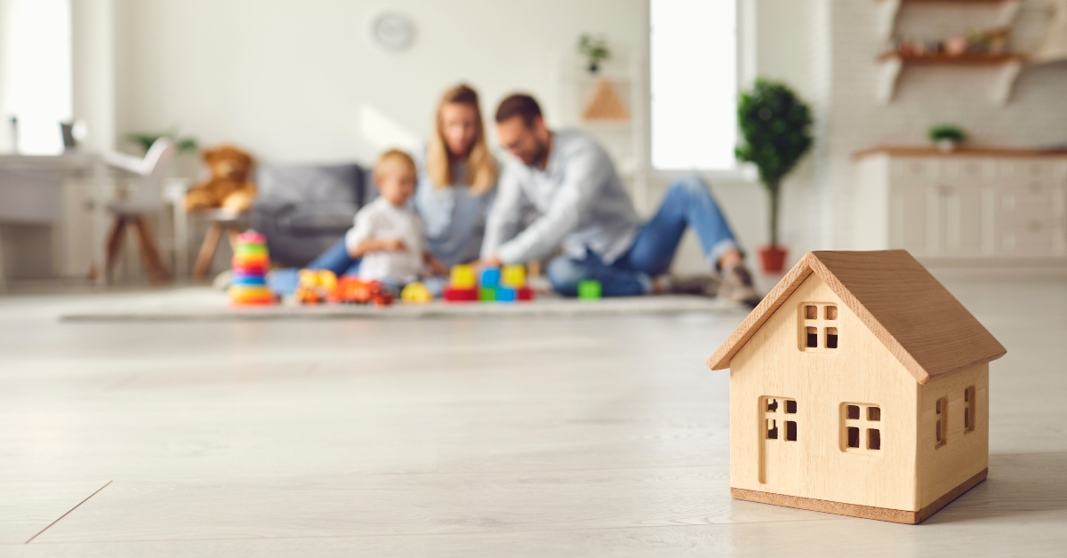 small wooden house on the background of a young family