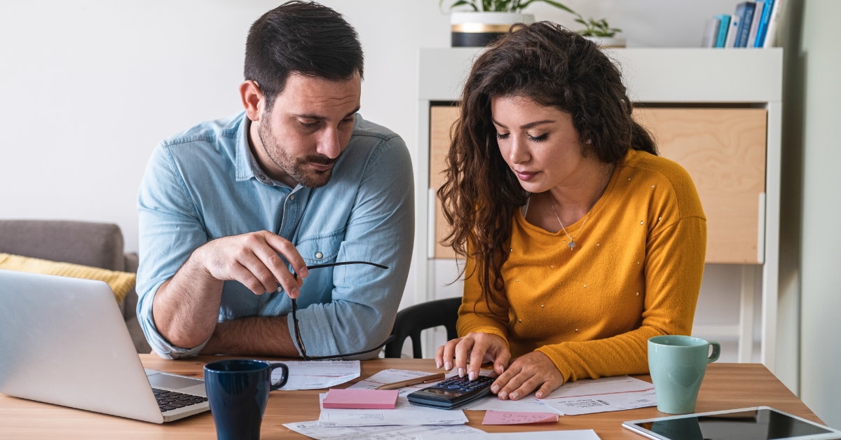 young couple calculating expenses