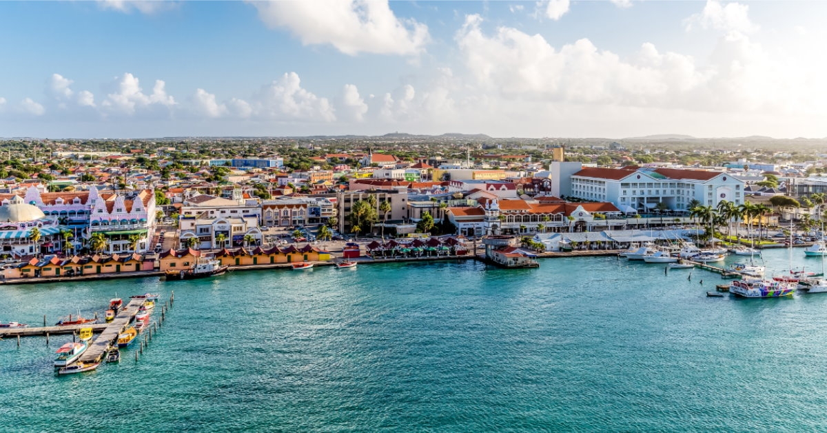 houses at waterfront with boats and yachts at oranjestad aruba marina during day time
