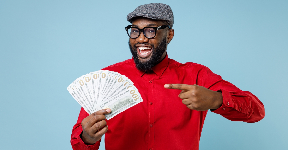 man pointing index finger on fan of cash money