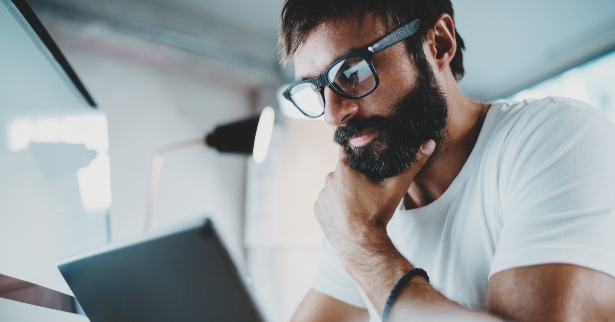pensive bearded designer working at the modern office loft