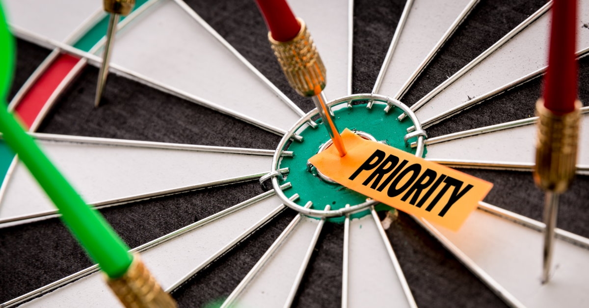 dart hitting bulls eye having priority label