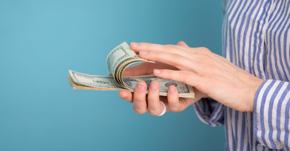 woman holding cash in hand