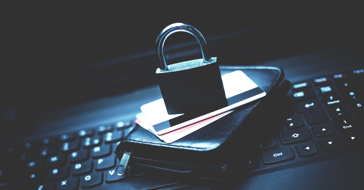 lock with credit cards and wallet on a laptop