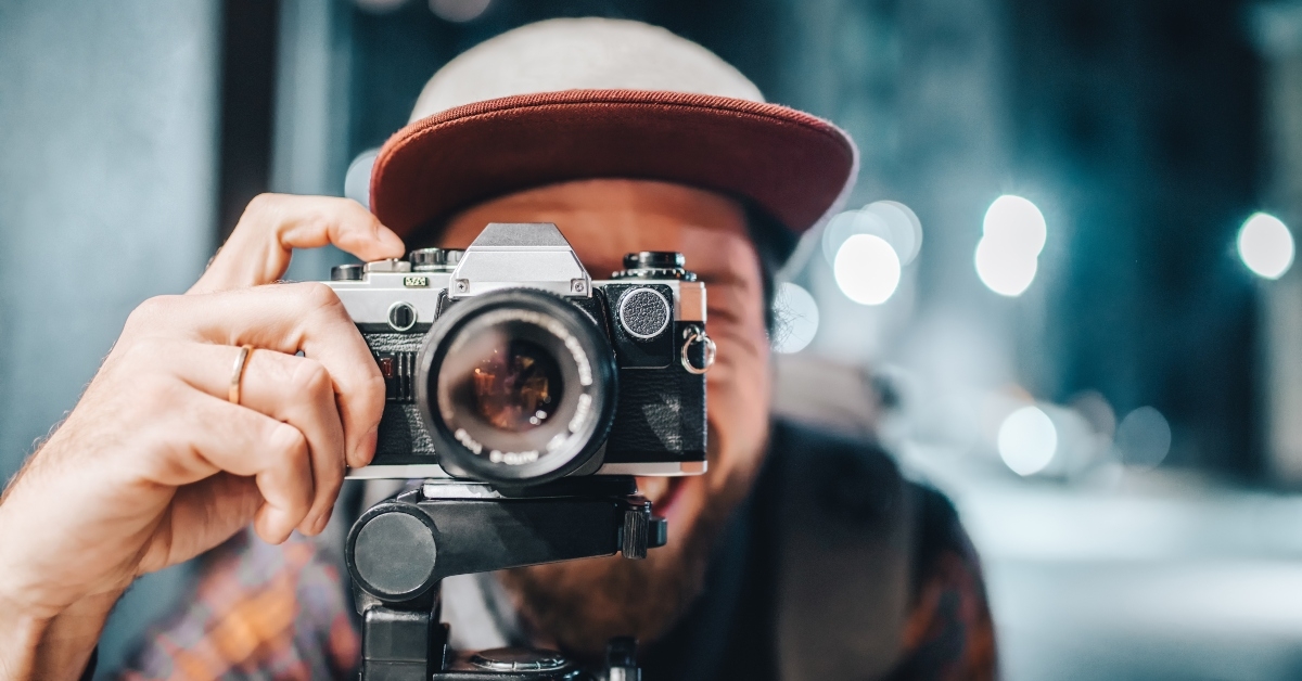 man taking photo on vintage film camera