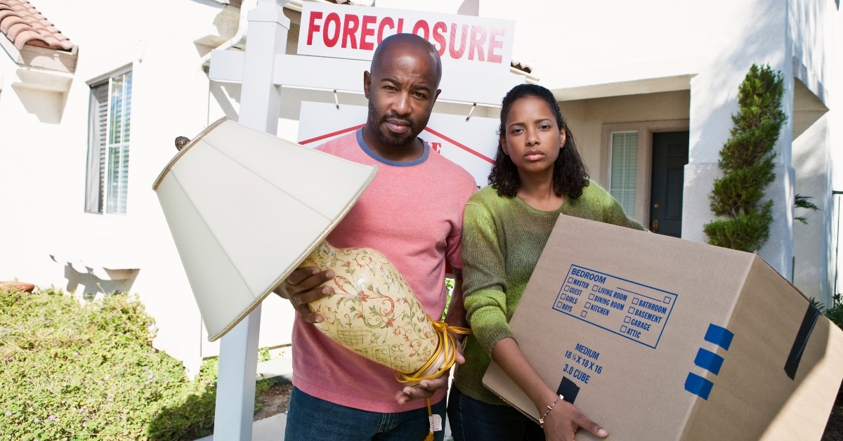 bankrupt couple with lamp and cardboard box
