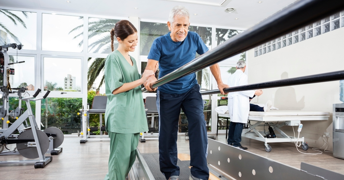 physiotherapist standing by smiling patient walking