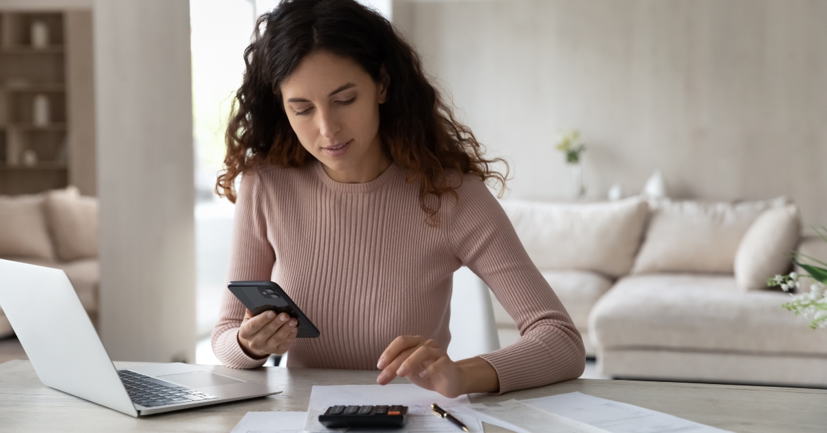 woman paying bills on smartphone