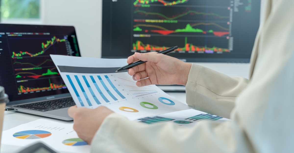 businesswoman calculates financial benefits from spreadsheets