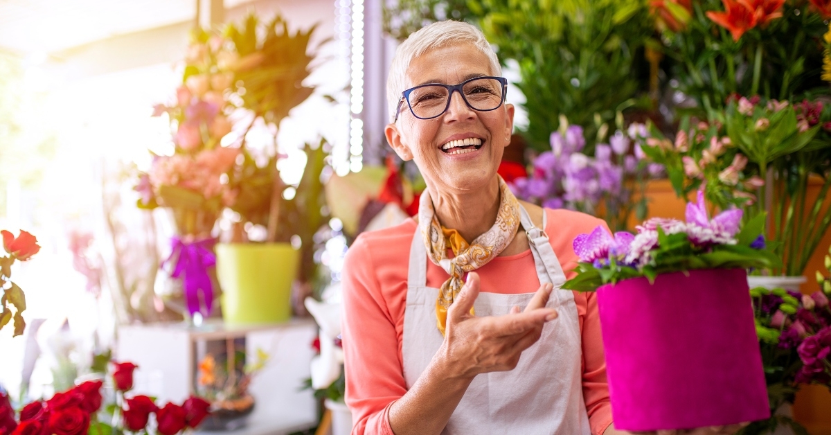 mature female florist with flower box