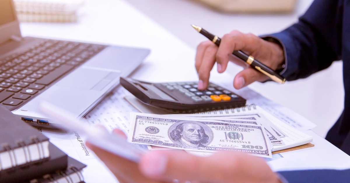 businessman working on his desk in the office with a calculator