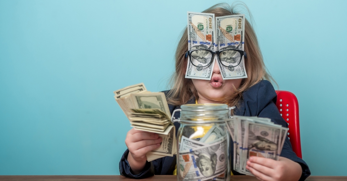 child with dollar bills shoved over glasses 