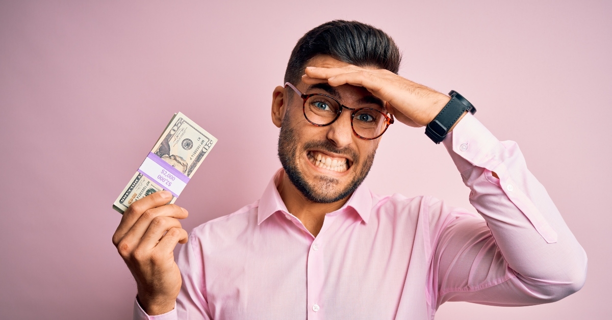 businessman holding bunch of 20 dollars