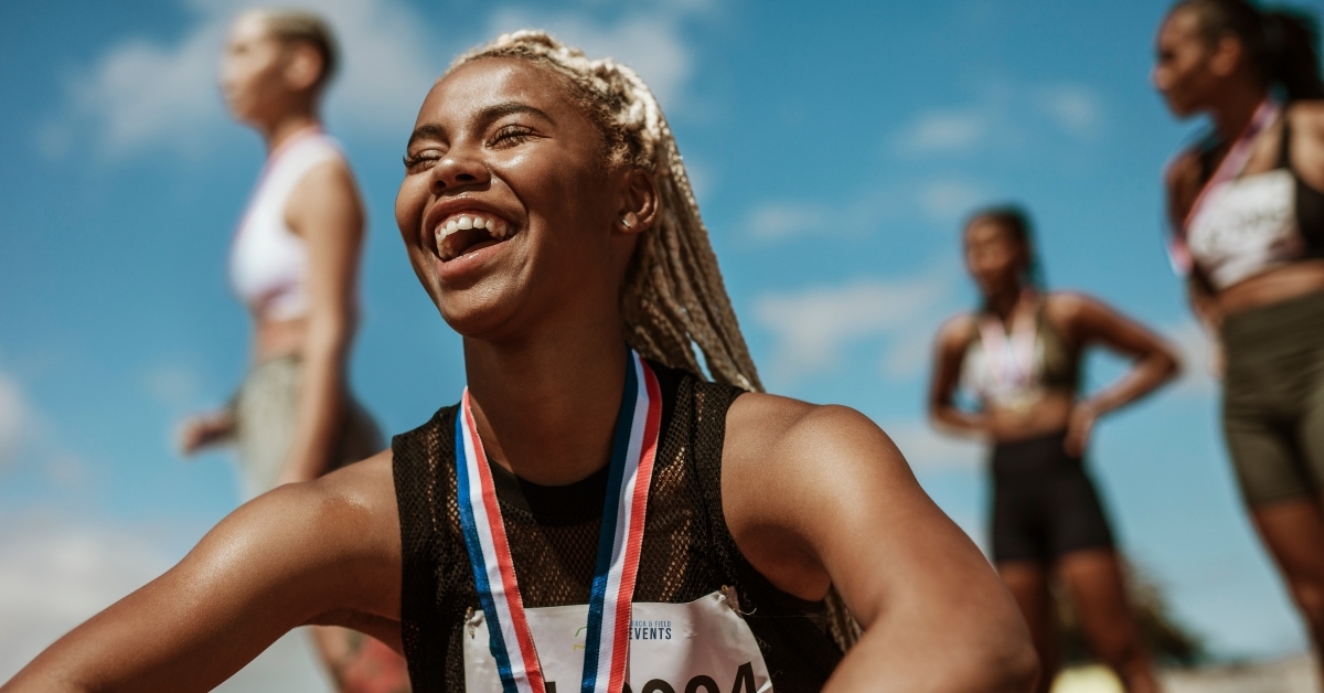 sportswoman with medal celebrating her victory 