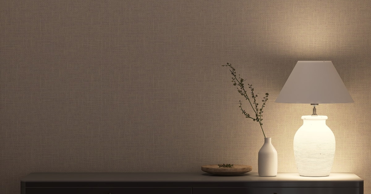 white lamp and vase with wooden plate on grey console table