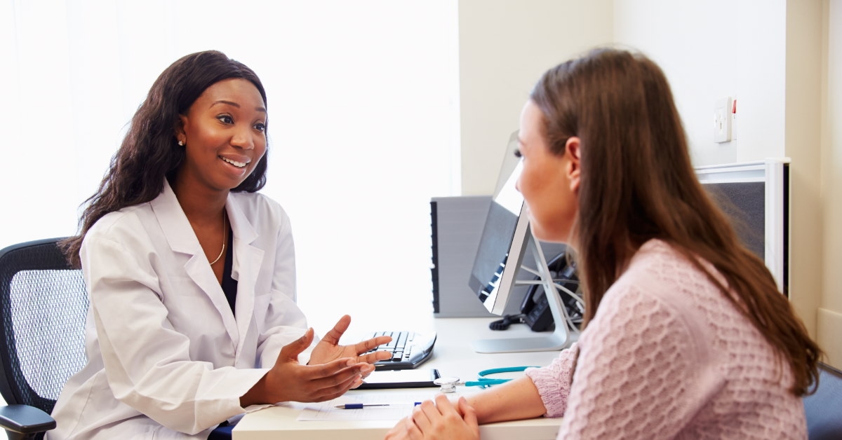 female patient in discussion with african american female doctor