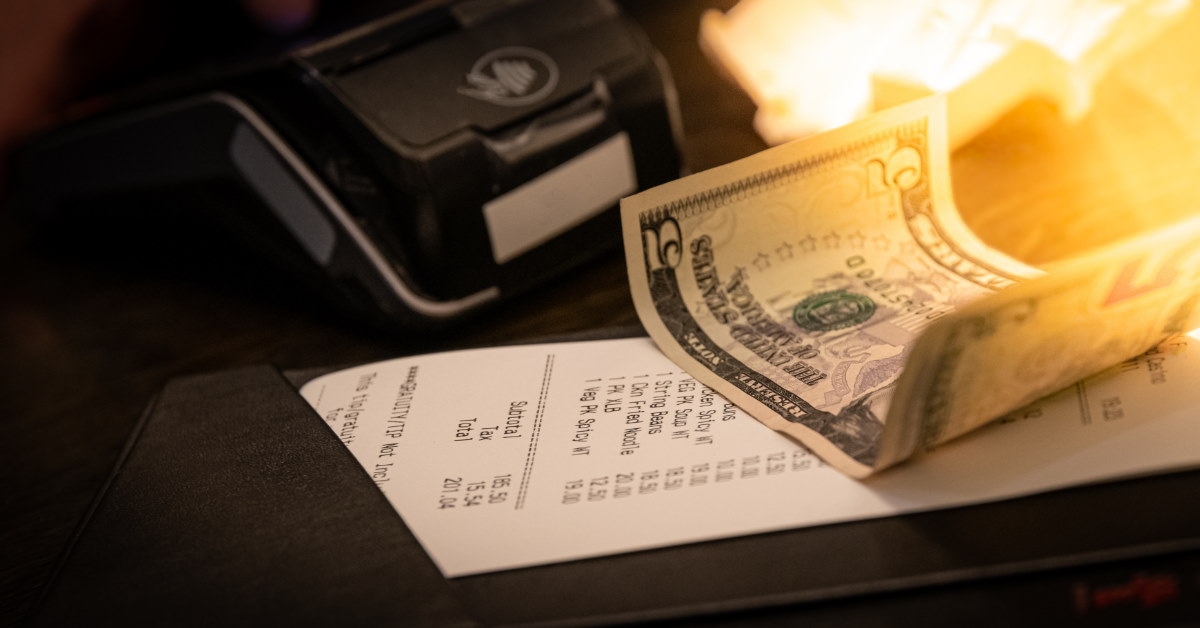 five dollar tip on restaurant bill in table