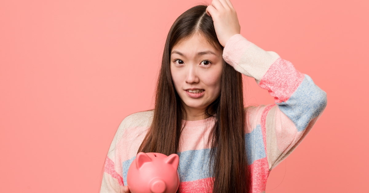 young woman holding piggy bank