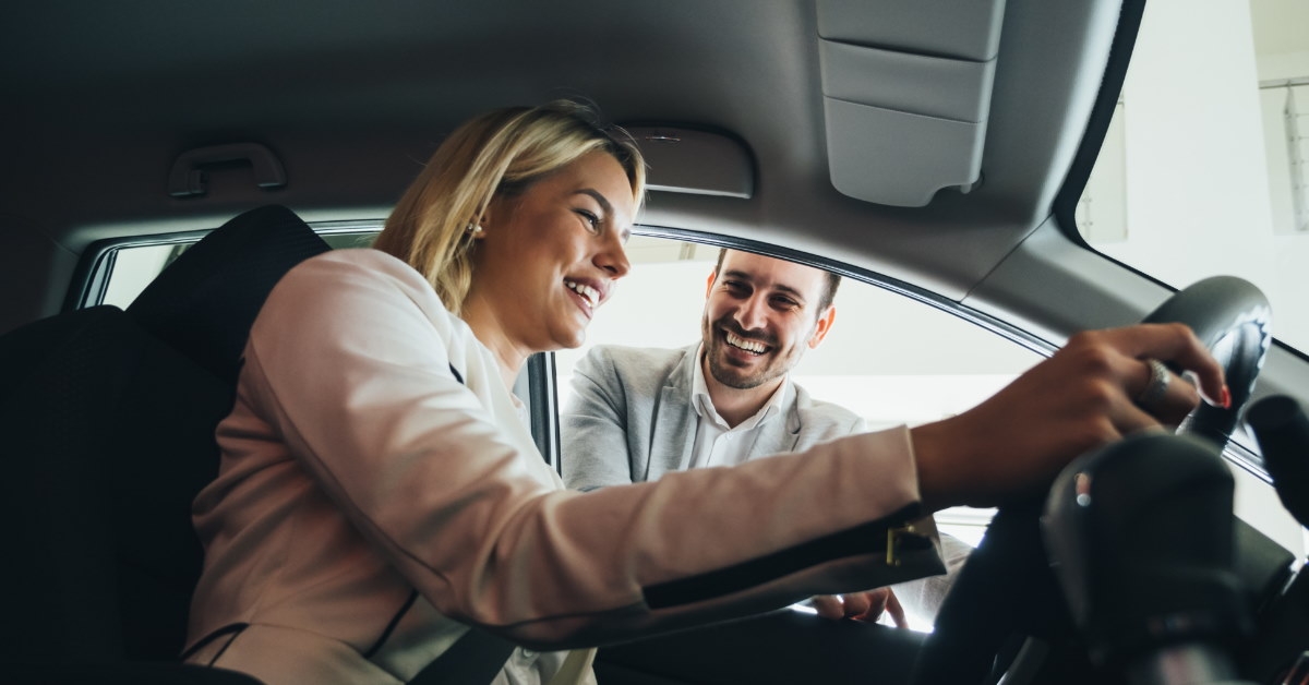 happy woman excieted while sitting in new car