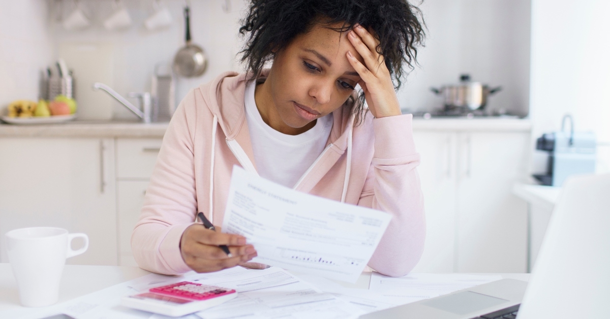 woman calculating debts feeling stressed