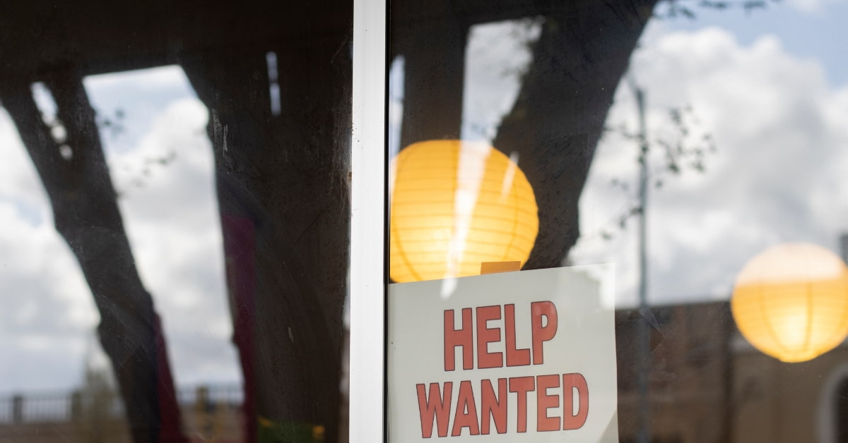front glass window of store with help wanted sign