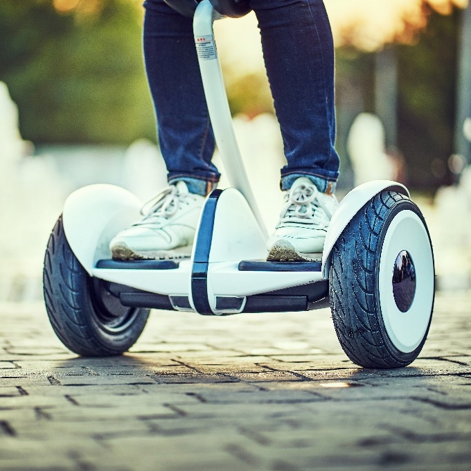 human legs and feet on hoverboard 