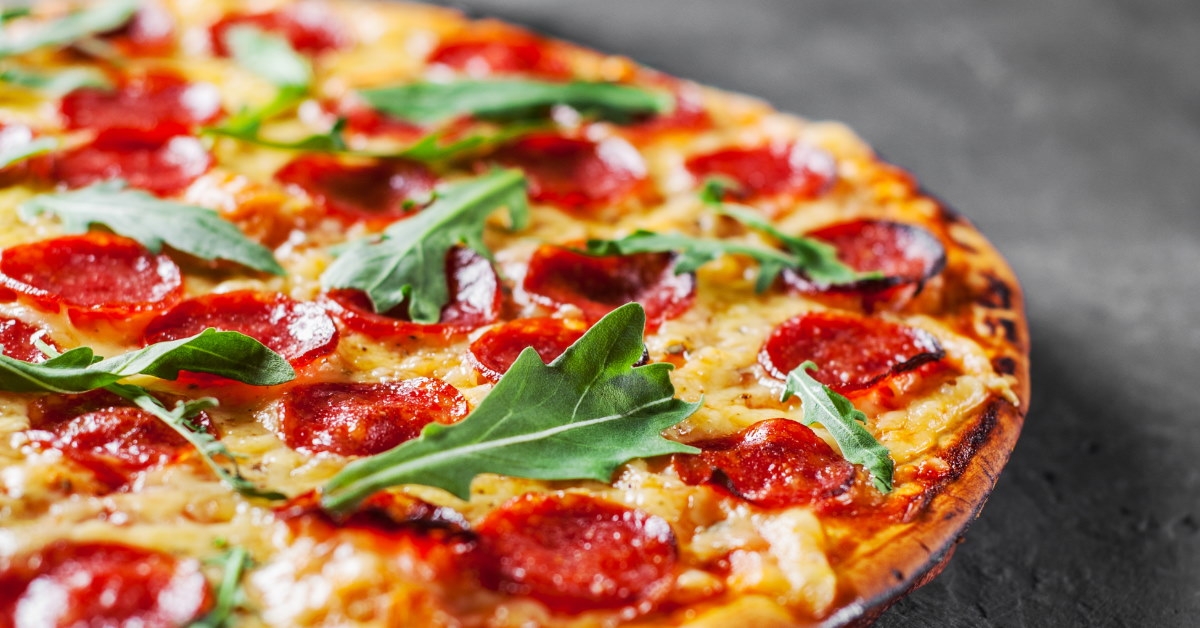 pepperoni pizza with mozarella cheese and basil leaves