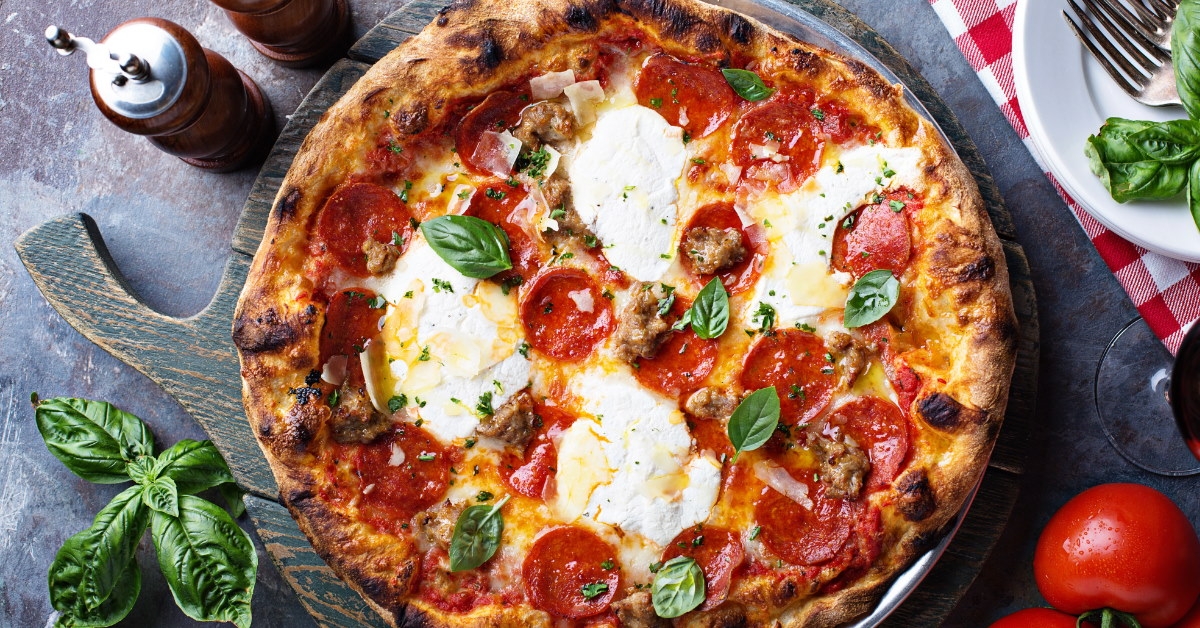 traditional italian pepperoni cheese pizza on wooden cutting board