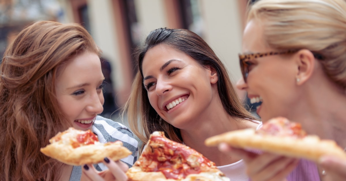 friends enjoying pizza and chatting 