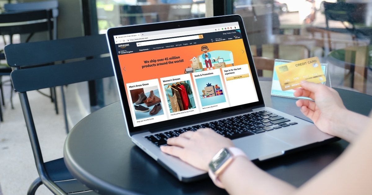 woman using laptop showing Amazon logo 