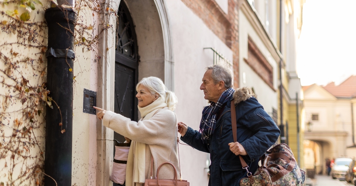 senior couple ringing the doorbell