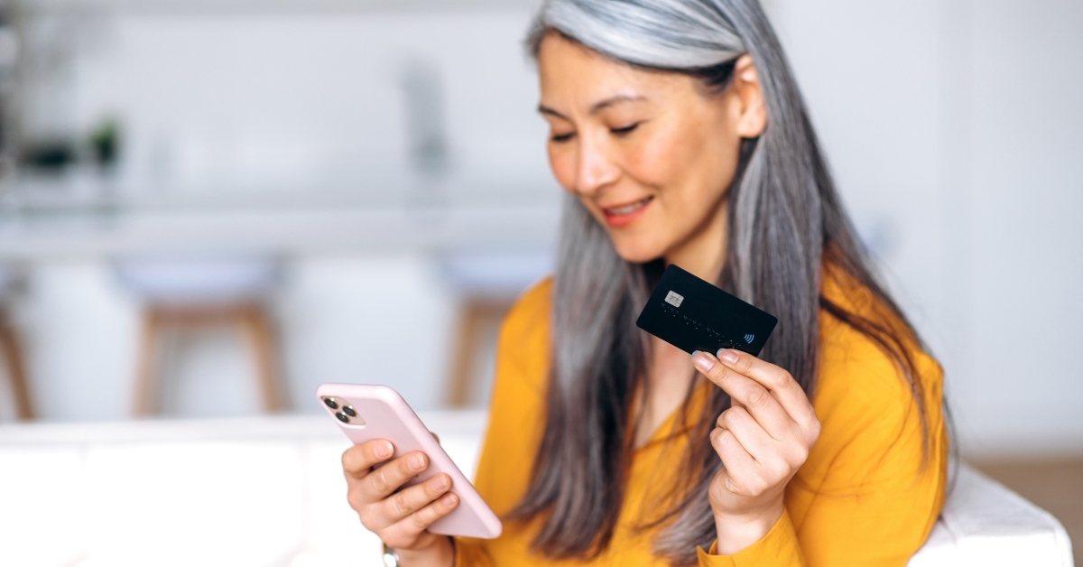 senior gray-haired woman is shopping online  