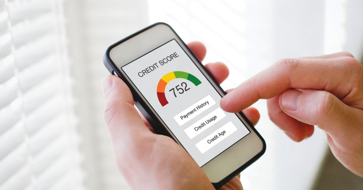 man holding smartphone with credit score on screen