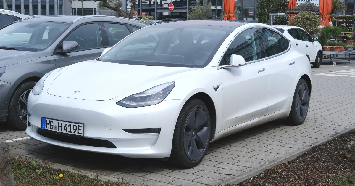white Tesla car model Y in parking